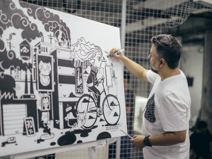 Artist creating mural with AIR-INK markers