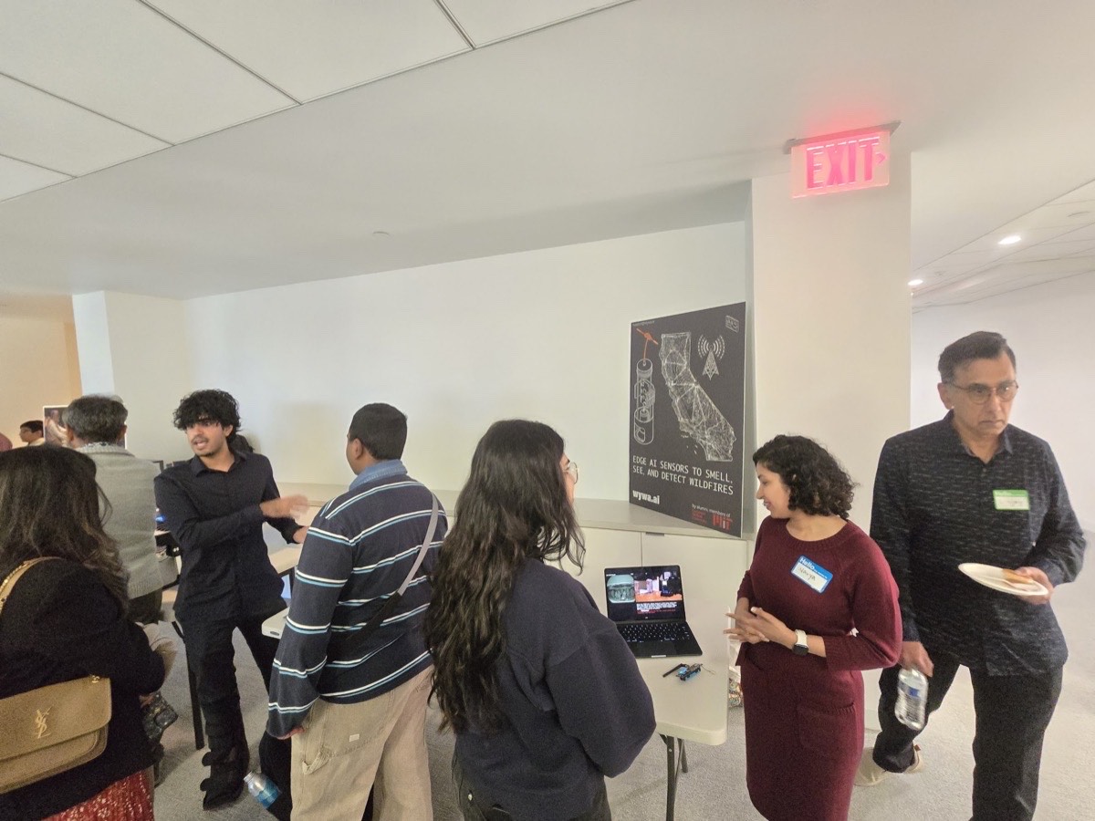 Navya at the WYWA demo table, explaining edge AI wildfire sensors to attendees